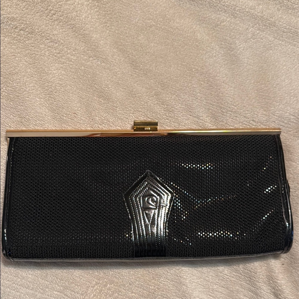 Vintage black clutch/purse with logo lined interior. Zipper interior side pouch